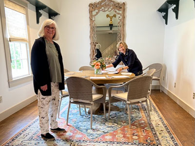 Two women setting a table