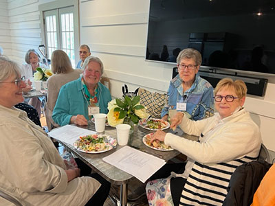 Group of women seated at a table about to eat