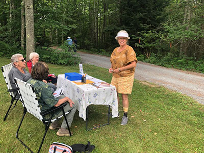 Several people outside at a table