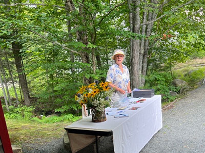 Woman standing at a table outside